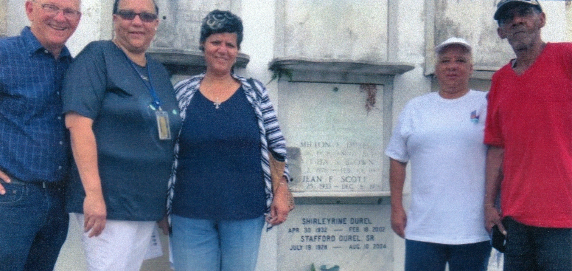 John Durel with the children of Stafford Durel at the tomb of their father