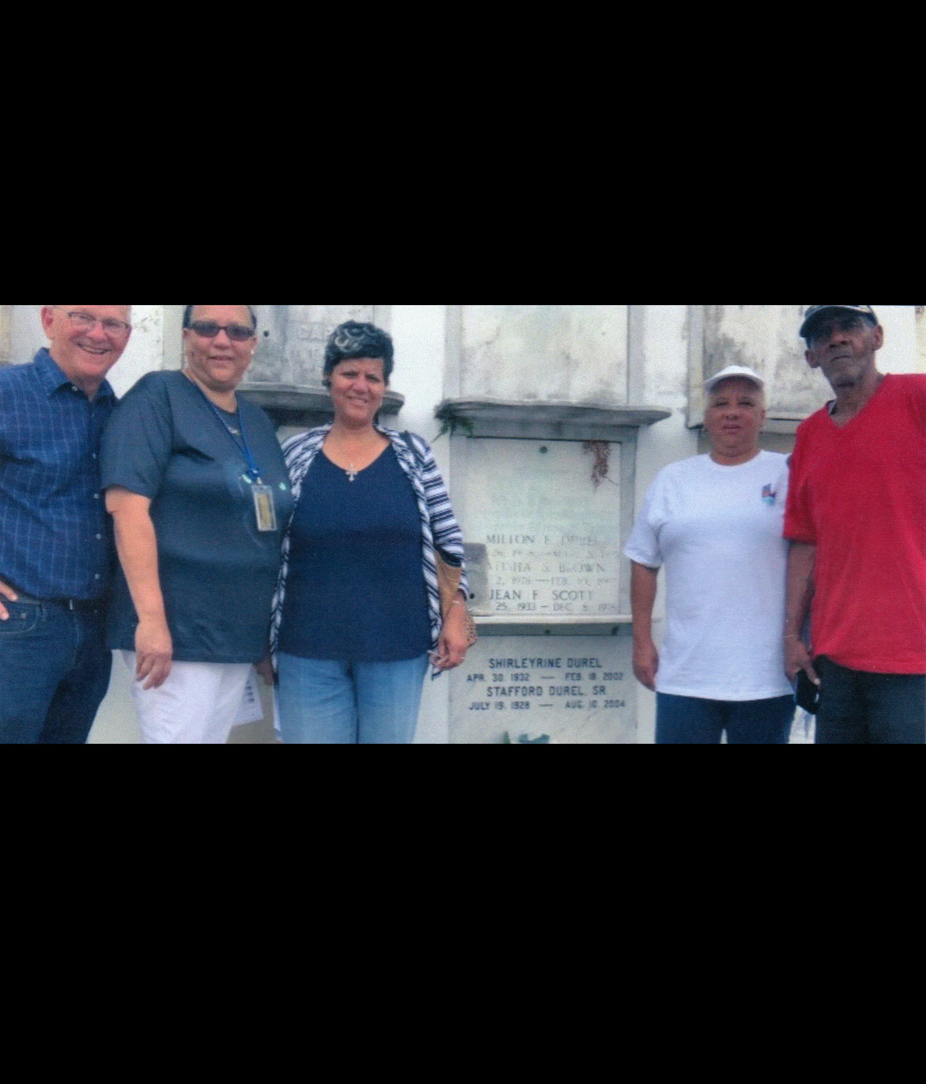 John Durel with the children of Stafford Durel at the tomb of their father